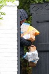 Ben Affleck grabs packages that were delivered to his house while sipping his coffee