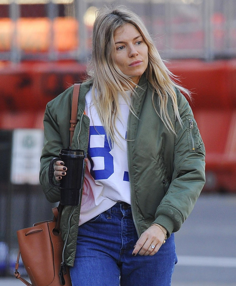 Sienna Miller shows off her rumored engagement ring as she hails a cab