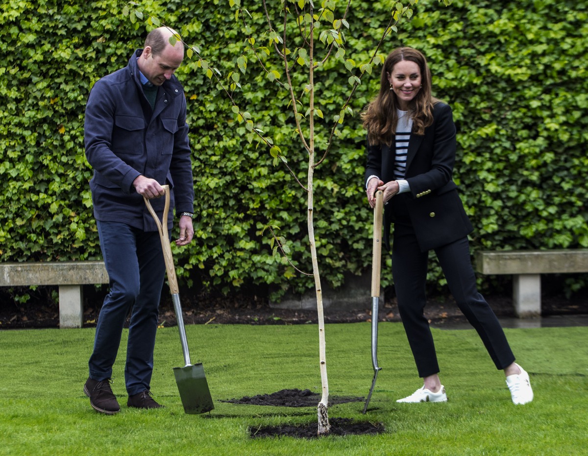 Britain's Catherine, Duchess of Cambridge and Britain's Prince William, Duke of Cambridge, take part in a tree planting ceremony as they visit the University of St Andrews in St Andrews on May 26, 2021.