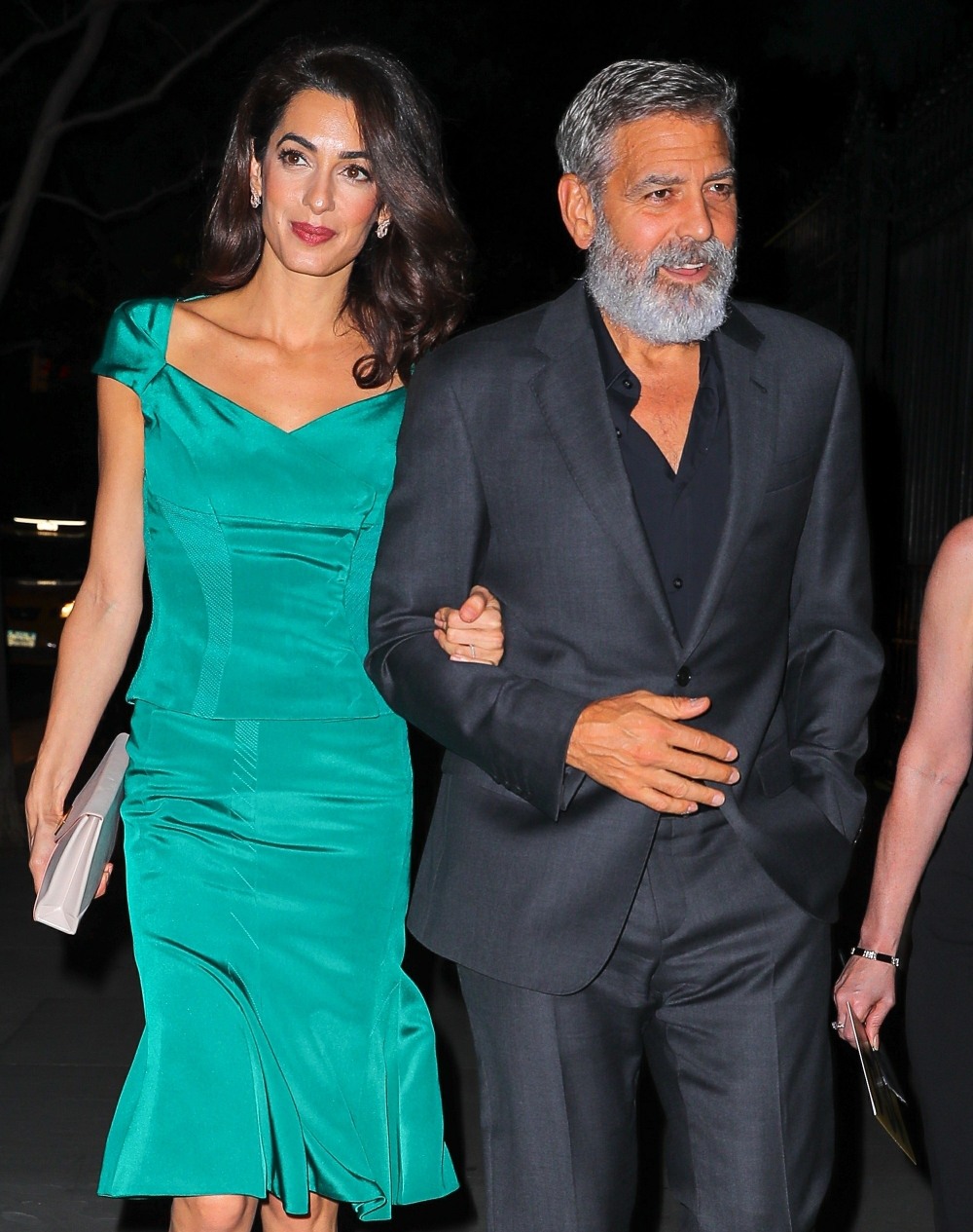 Amal Clooney and George Clooney walk arm-in-arm after a law benefit in NYC
