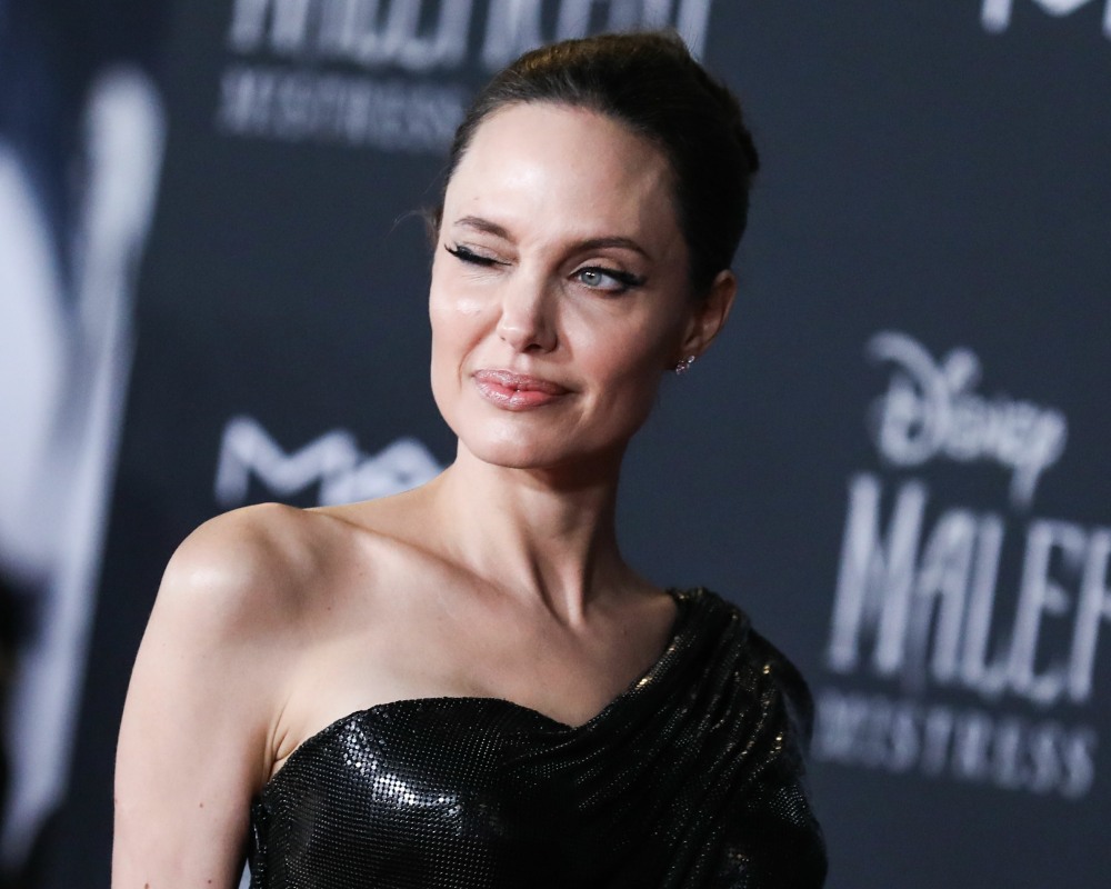 Actress Angelina Jolie wearing Atelier Versace with Cartier jewelry arrives at the World Premiere Of Disney's 'Maleficent: Mistress Of Evil' held at the El Capitan Theatre on September 30, 2019 in Hollywood, Los Angeles, California, United States.