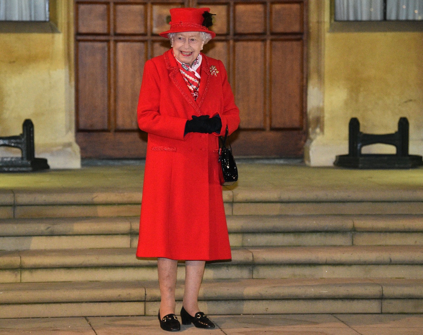 Britain's Queen Elizabeth II reacts as she waits to thank local volunteers and k