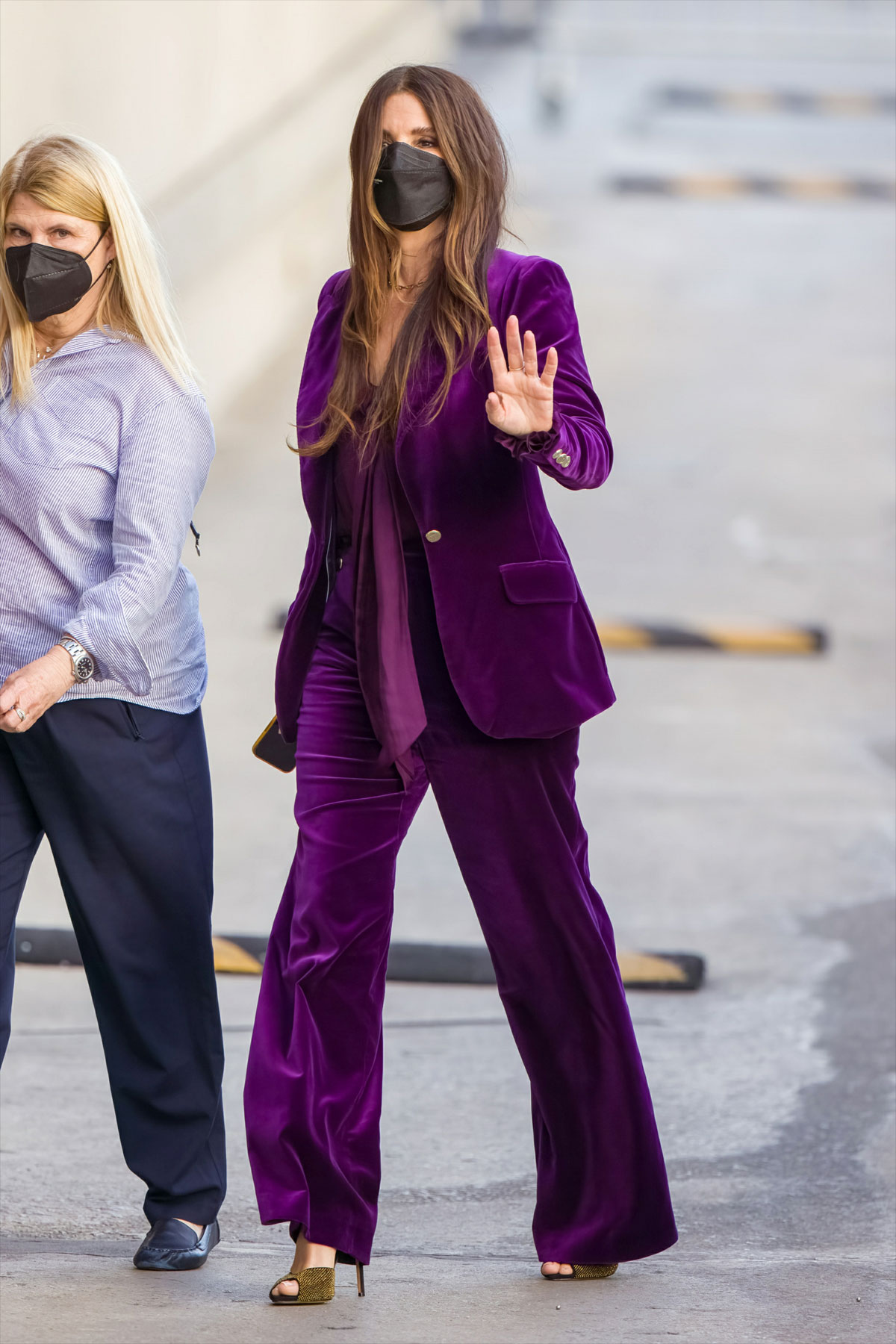 Sandra Bullock outside Kimmel's studios wearing a purple suit and a black mask