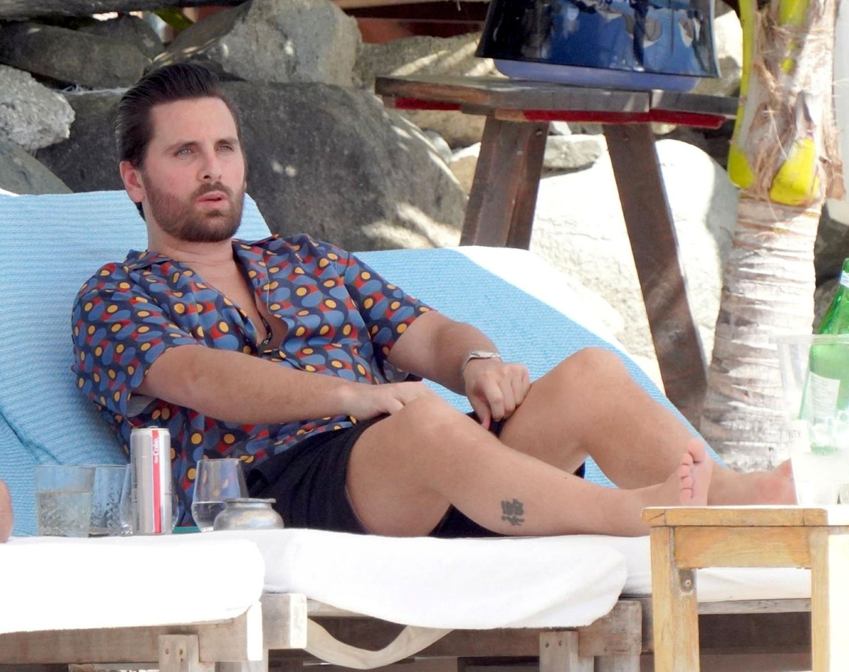 Scott Disick looks zen lounging with a group of friends on his sun soaked holiday in St Barts.