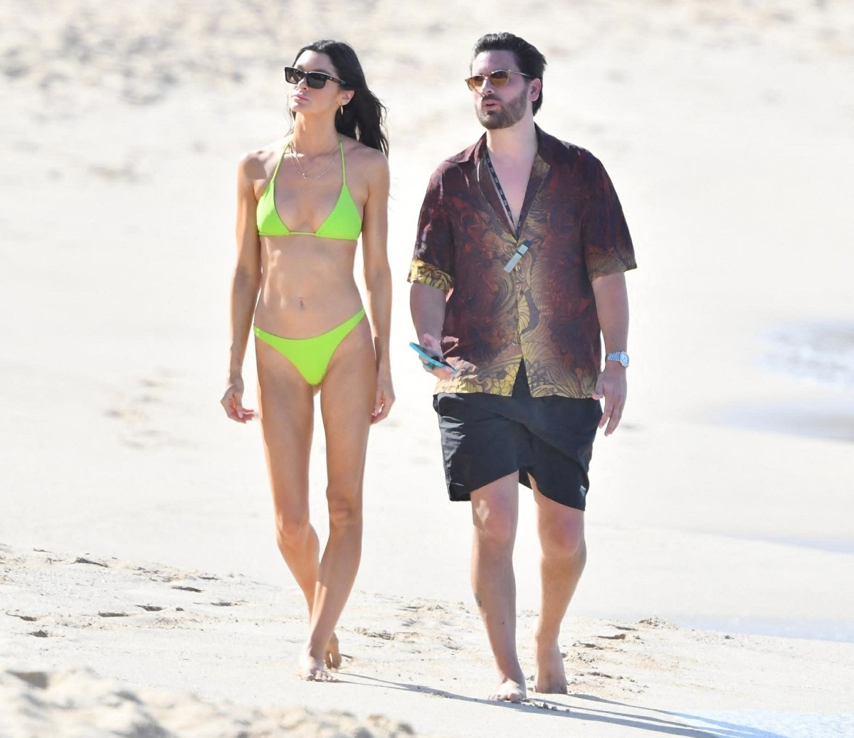 Scott Disick and Bella Banos take a stroll on the Beach