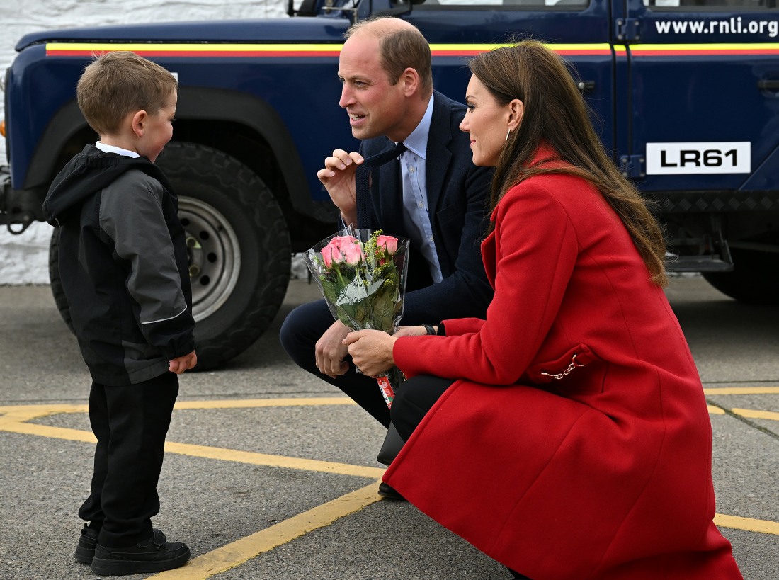 A small child waited four hours to in the cold to hand flowers to Princess Kate