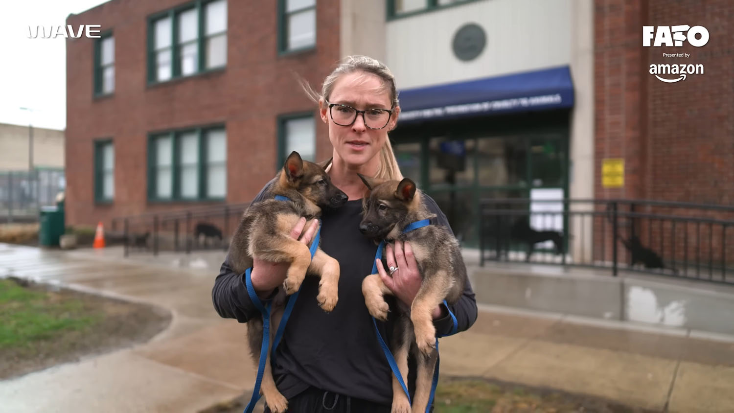 Kylie Kelce holding two German Shepherd puppies