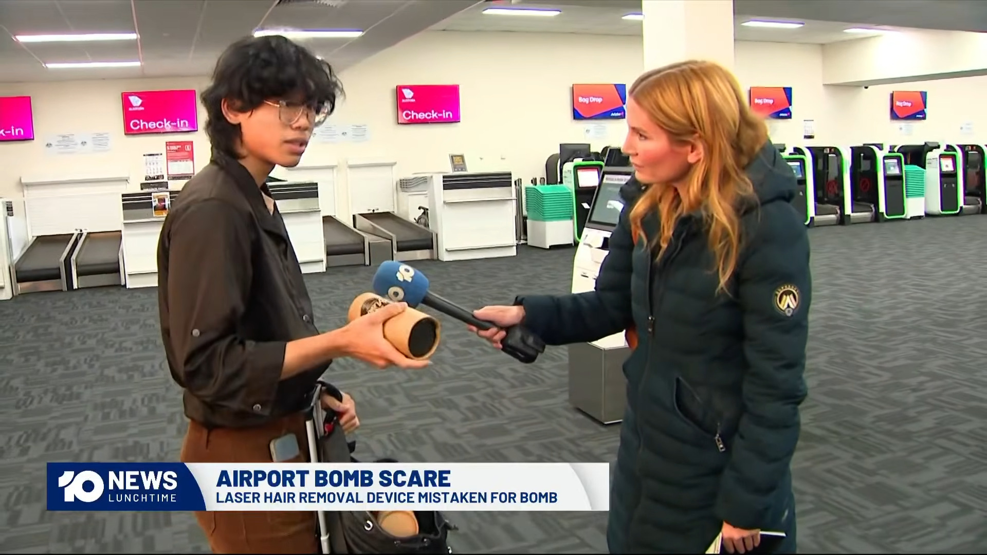 Young man holding hot chocolate canister and talking to journalist at Avalon airport
