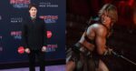 Nicholas Galitzine at the Masters of the Universe Premiere next to a photo of him looking jacked in the trailer