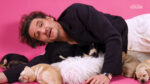 Screenshot from Pedro Pascal's Buzzfeed Puppy interview. He's lying on the floor with puppies around him