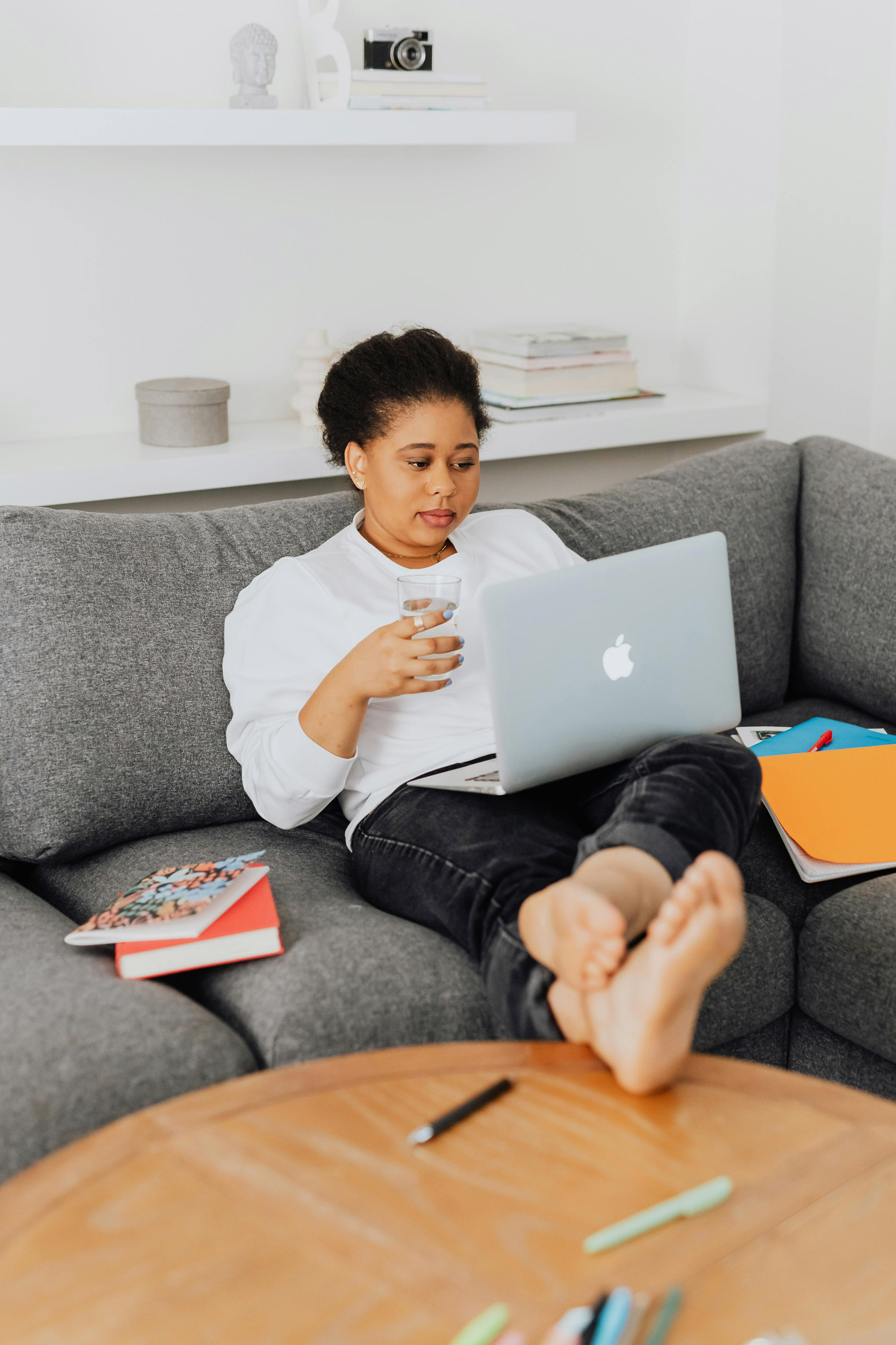 Woman sitting on the couch and looking at her laptop