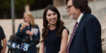 Michelle Hadley smiling at her lawyer during a press conference