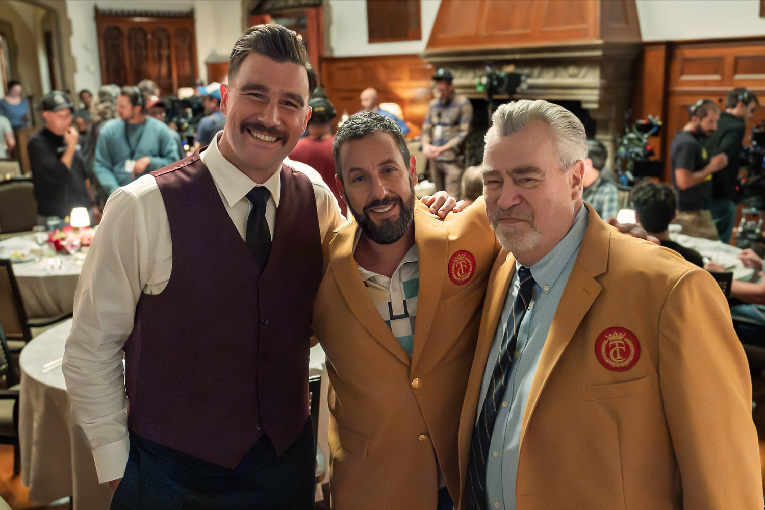 Travis Kelce as The Waiter, Adam Sandler as Happy Gilmore (Writer/Producer), and Ed Kelce on the set of Happy Gilmore 2