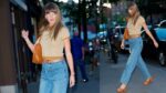 Taylor Swift in jeans and a cap sleeve sweater outside the studio