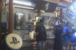 Young men playing video games at an event