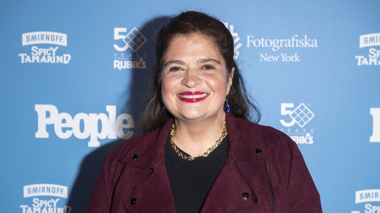 Alex Guarnaschelli in a burgundy suede moto jacket at PEOPLE: Celebrating 50 Years exhibition opening at Fotografiska on 05/09/2024