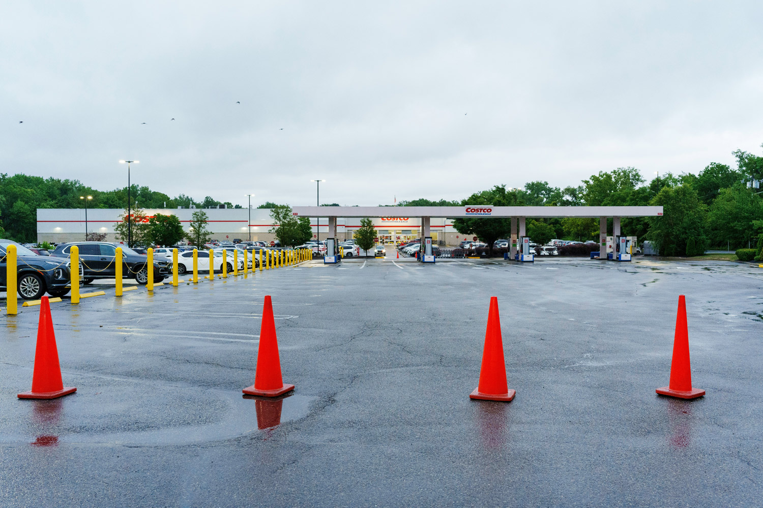 Costco Gas station in front of Costco warehouse with orange cones blocking the pumps