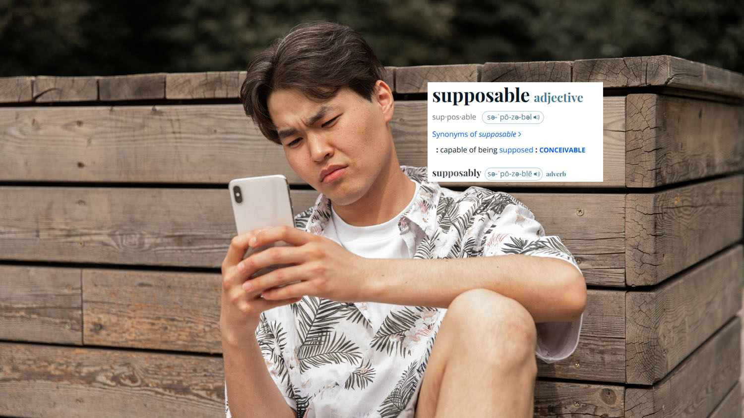 Man sitting looking confused at his phone with his face scrunched up. The definition for "supposable" is pasted in next to him