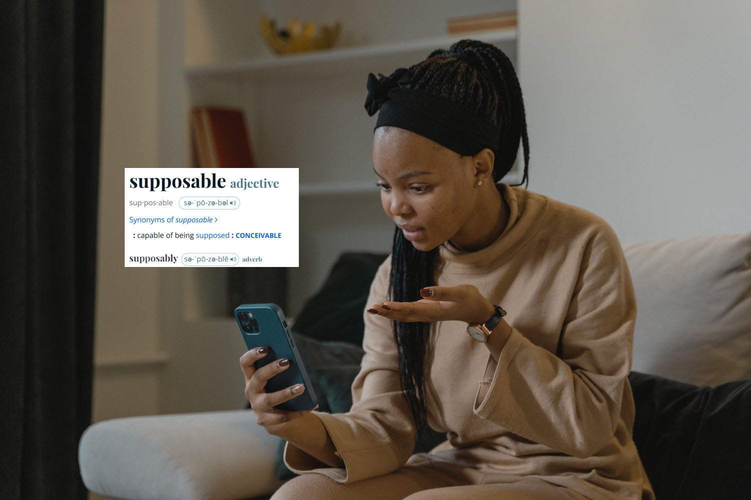 Woman sitting on the couch looking at ther phone with her hand held up like 'what the hell?' The definition for "supposable" is pasted next to her