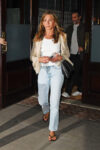 paparazzi photo of Jennifer Aniston walking ahead of Jim Curtis
