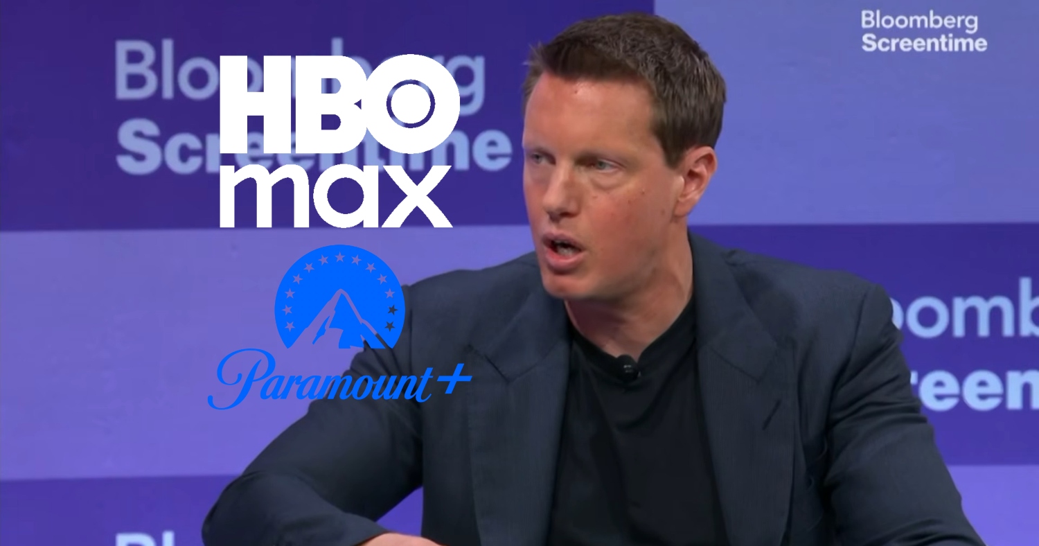 David Ellison with his mouth open during an interview next to logos of HBO Max and Paramount Plus