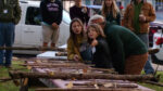 Children judging straightest stick contest