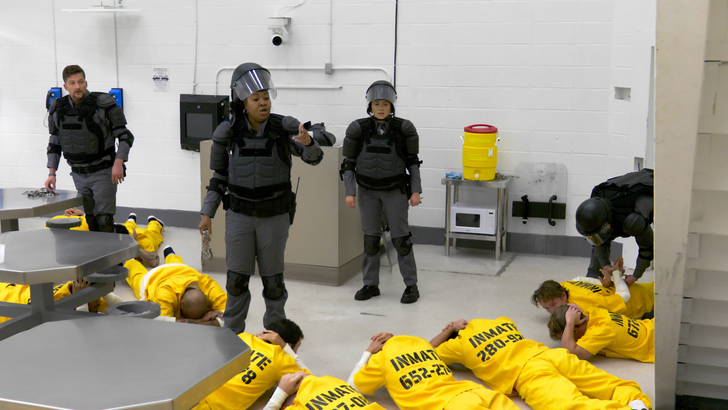 Guard lecturing prisoners on ground
