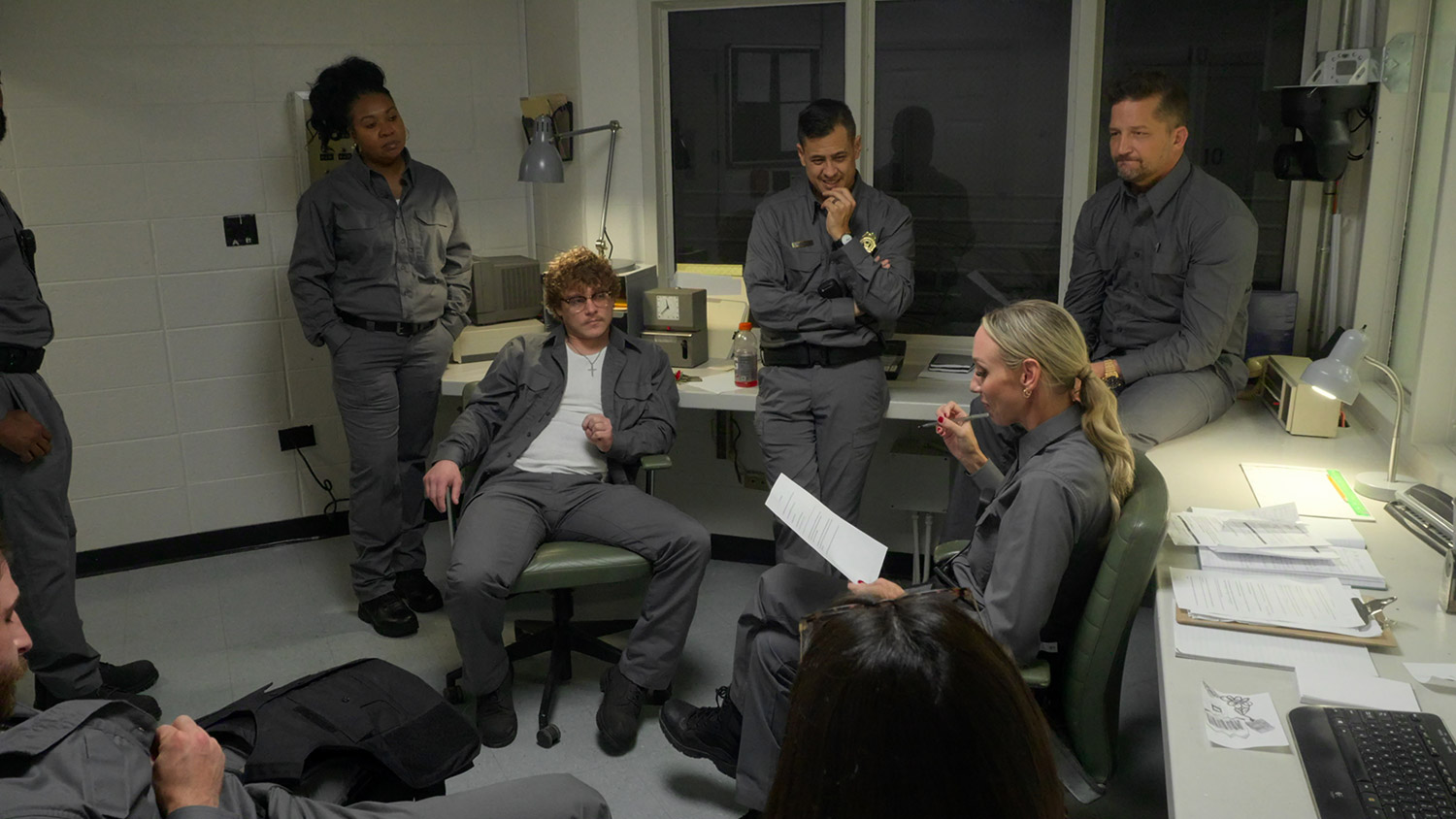 Prison guards in control room plotting