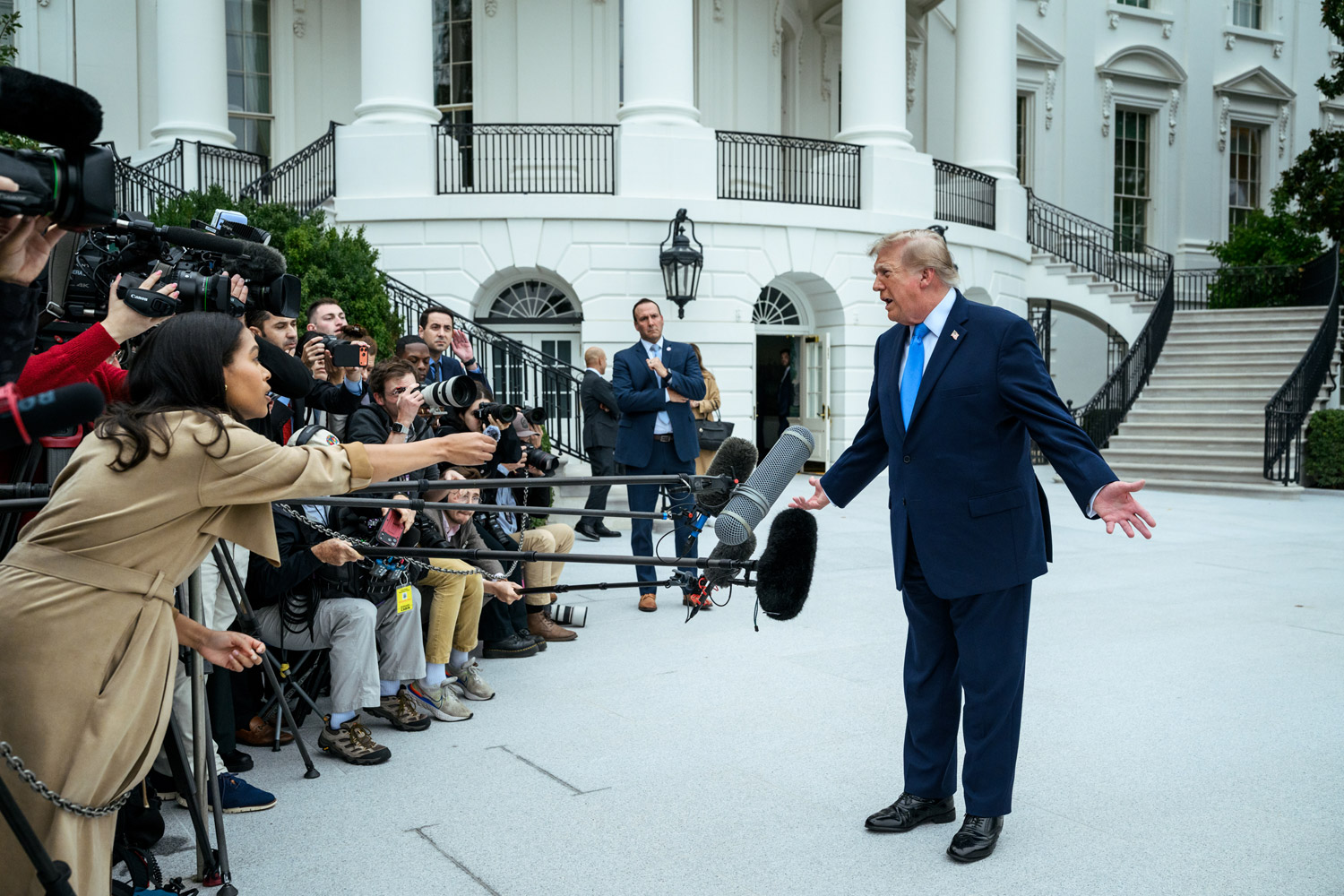 Trump speaks with members of the media on the South Lawn before boarding Marine One en route to Joint Base Andrews, Saturday, October 3, 2026.